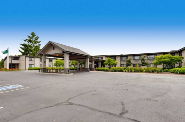 daytime view of cascade in assisted living facility in vancouver washington showing well manicured bushes and trees around the exterior