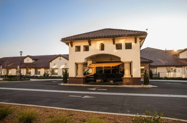 exterior daytime view of the memory care community in elk grove showing the building and the parking lot turn in for drops offs and pick ups